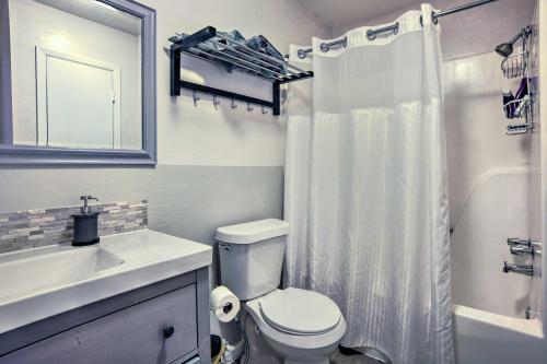 a white bathroom with a toilet and a sink at Pet-Friendly Bryan Escape about 2 Mi to Texas AandM in Bryan