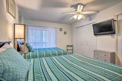 a bedroom with two beds and a flat screen tv at Pet-Friendly Bryan Escape about 2 Mi to Texas AandM in Bryan