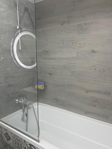 a bathroom with a shower and a bath tub at Panorama 901 in Oradea