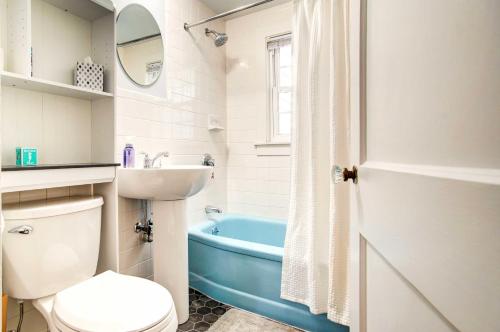 a bathroom with a toilet and a sink and a tub at Hyannis Getaway about 2 Mi to Beach! in Hyannis