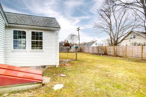 a yard with a house and a fence at 2 Mi to Beach Coastal Retreat in Hyannis! in Hyannis