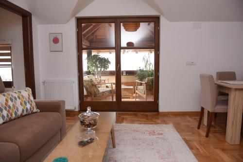 a living room with a couch and a table at Seosko turističko domaćinstvo Kajsija in Čačak