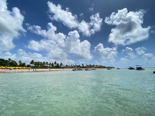 a view of a beach with boats in the water at Casa de Dora in São Miguel dos Milagres