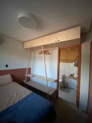 a bedroom with a bunk bed and a bathroom at Casa de Dora in São Miguel dos Milagres