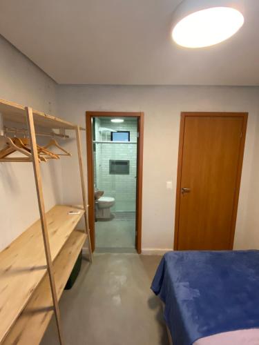 a bedroom with a bunk bed and a bathroom at Casa de Dora in São Miguel dos Milagres