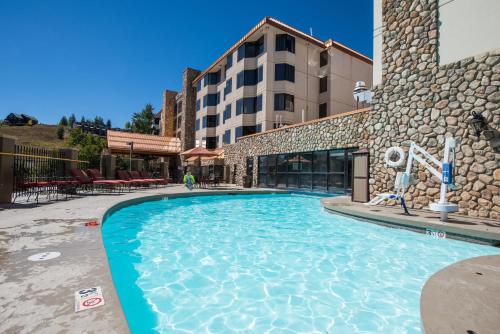 a swimming pool in front of a hotel at The Grand Lodge Hotel and Suites in Mount Crested Butte