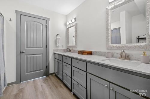 a bathroom with a sink and a mirror at Alyce Retreat - Nature, Trails and Lake Escape in Bella Vista