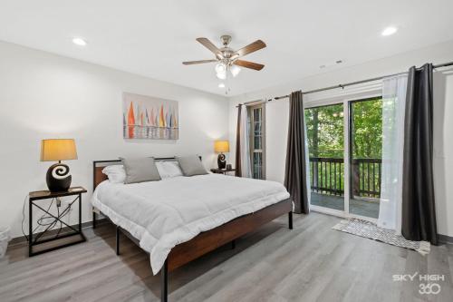 a bedroom with a bed and a ceiling fan at Alyce Retreat - Nature, Trails and Lake Escape in Bella Vista