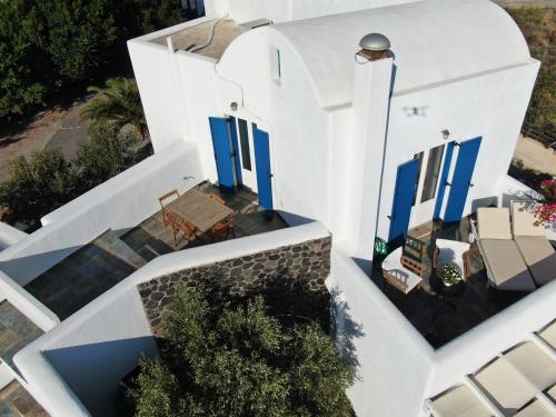 an overhead view of a white house with blue doors at Arcana Santorini Villas, An Authentic Cycladic Experience in Akrotiri