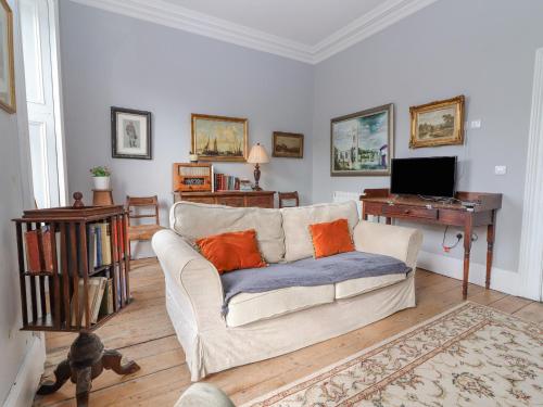 a living room with a couch and a television at The Merchant's House in Kilrush