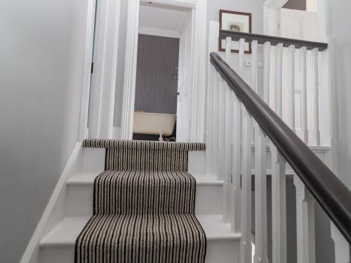 a stairway with a brown and white striped stair case at The Merchant's House in Kilrush