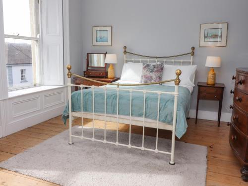 a bedroom with a bed with a metal frame at The Merchant's House in Kilrush