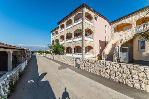 a shadow of a person walking down a street next to a building at Apartmani Ivanic in Vir