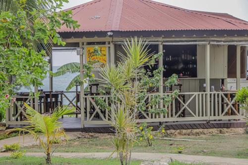 a building with a porch and a restaurant at Little Bay Hideaway in Little Bay