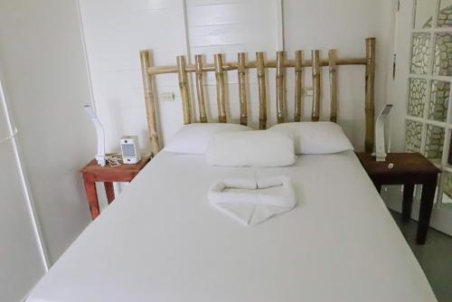 a bedroom with two beds with white pillows at Little Bay Hideaway in Little Bay