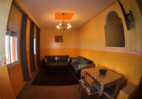 a living room with a couch and a table at Coopérative Village Jbel Moussa du Tourisme in Rcham
