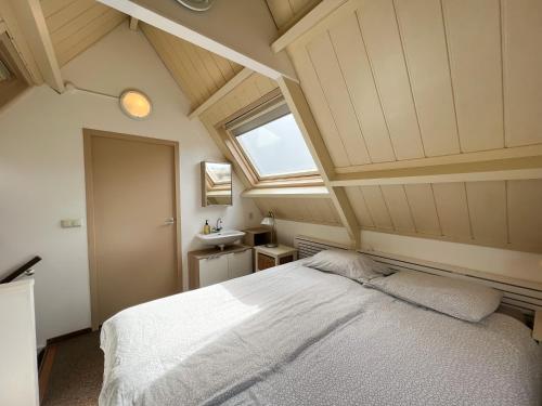 Vakantiewoning aan Zee - 150m van het Strand في إغموند آن زي: غرفة نوم بها سرير أبيض كبير مع نافذة