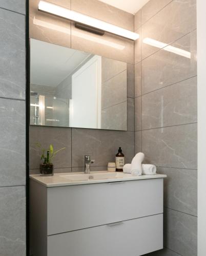 a bathroom with a sink and a mirror at Zeev Jabotinsky Residence - With Mamad in Tel Aviv