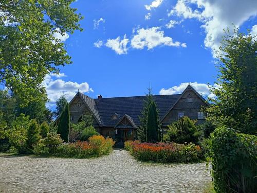 a large house with a garden in front of it at Wejmutka, Białowieża in Białowieża