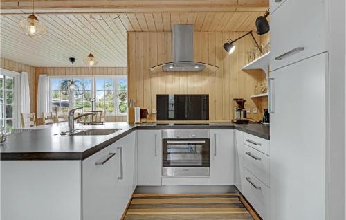 a kitchen with white cabinets and a sink at Nice Home In Sydals With Kitchen in Neder Lysabild