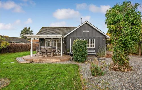 a black house with a deck and a yard at Nice Home In Sydals With Kitchen in Neder Lysabild
