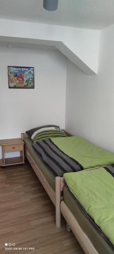 a bedroom with two twin beds and a table at Perle im Zentrum in Eschwege