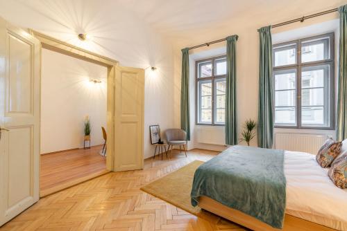 a bedroom with a bed and a large window at Primavera - Castle view apartments in Prague