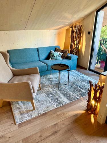 a living room with a blue couch and a table at Apartmán Tri Smreky Demänovská Dolina in Demanovska Dolina