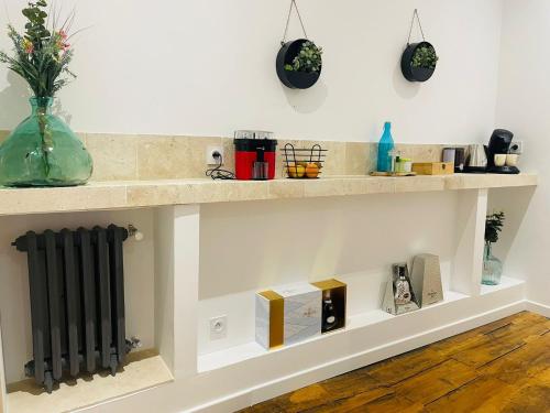 a shelf in a kitchen with a radiator at Les Dames Jeannes in Jarnac