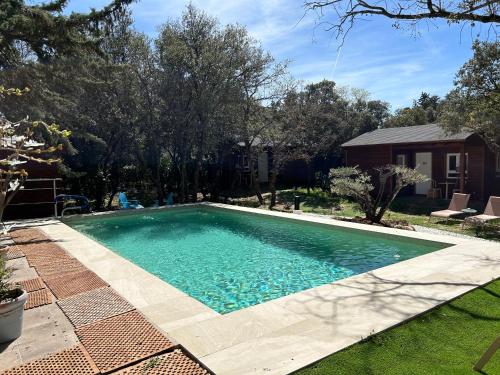 a swimming pool in the yard of a house at De Rafael Cabañas de Madera in Venturada