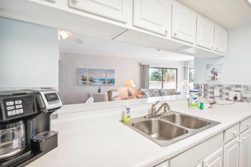a kitchen with a sink and a microwave at Land's End 1-307 Gulf View in St. Pete Beach