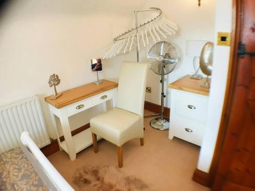 a room with a desk with a chair and a lamp at 2 Bed Classy Peak District Cottage Barn Near Alton Towers, Polar Bears, Chatsworth House in Whiston