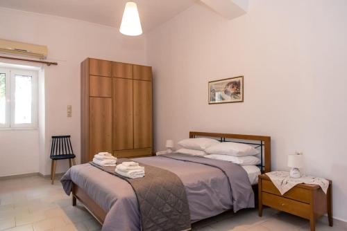 a bedroom with a bed and a dresser in it at Konstantina's Fairytale House in Kissamos