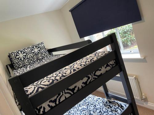 a black bunk bed with a pillow on top at Sea-Haven on Sunrise Ground Floor Holiday Home The Bay Filey in Filey