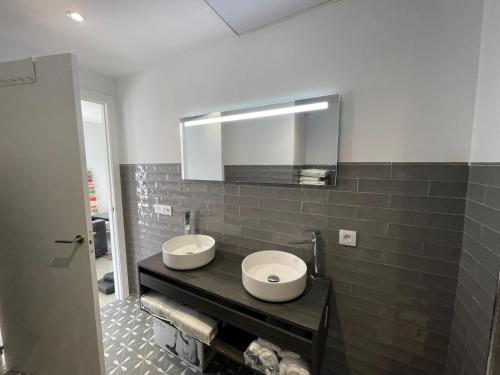 a bathroom with two sinks and a mirror at El Mentidero AT-CC-00762 in Coria