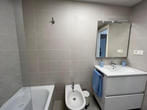 uma casa de banho com um lavatório, um WC e um espelho. em Apartamento Aguacate beach playa Granada em Motril