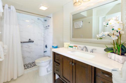 a bathroom with a sink and a shower and a toilet at Panoramic Mountain View Condo with Free Parking! in Honolulu