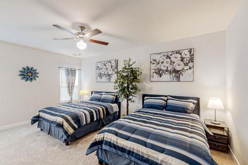 a bedroom with two beds and a ceiling fan at A Home Away from Home in North Myrtle Beach