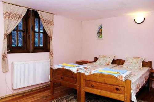 A bed or beds in a room at Melnik Pyramids Guesthouse