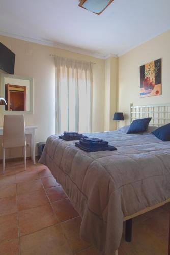 a bedroom with a large bed and a desk at Apartment Isla Canela Luxury in Huelva
