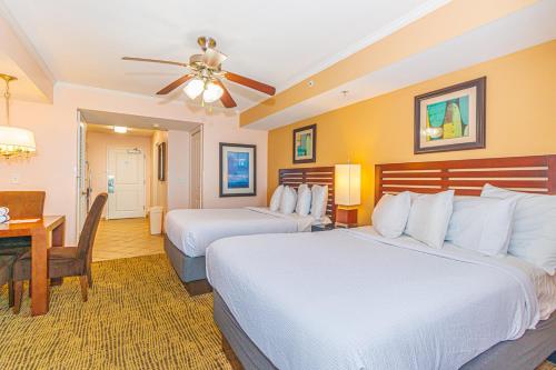 a hotel room with two beds and a desk at Towers On The Grove 724 Direct Oceanfront Suite Sleeps 6 guests in Myrtle Beach