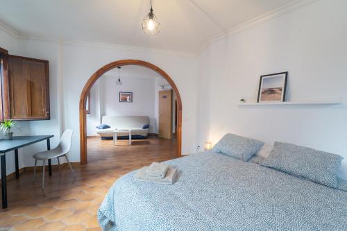 a bedroom with a bed and a table and a room at Un Lugar House San Telmo -Coliving in Las Palmas de Gran Canaria
