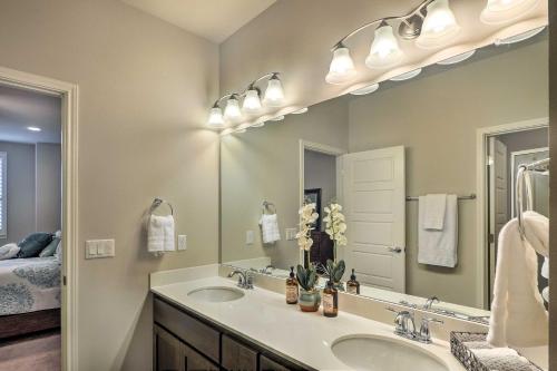La salle de bains est pourvue de 2 lavabos et d'un grand miroir. dans l'établissement Upscale and Modern Austin Townhome with Pool Access!, à Austin
