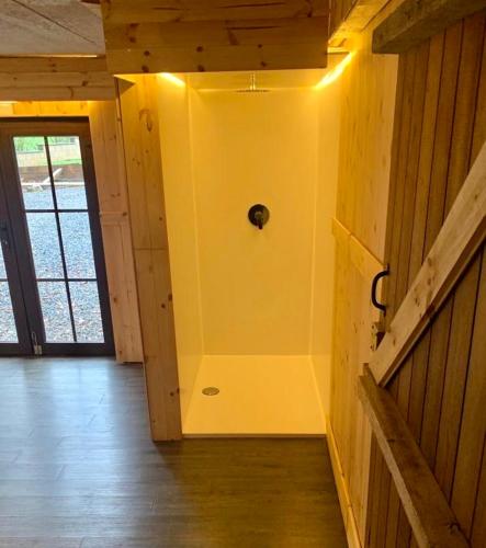 a room with a yellow wall with a door at Villa Dhoris in Ferrières