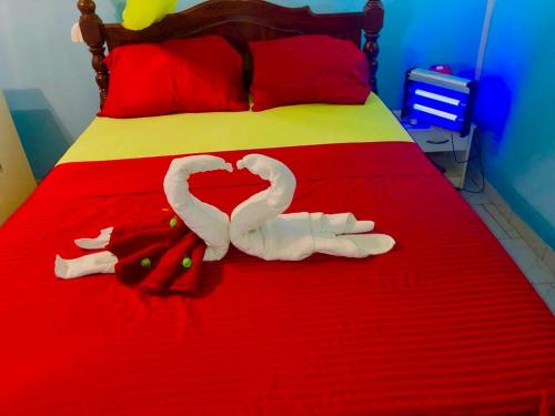 two swans making a heart on a bed at Maison de 2 chambres avec vue sur la mer spa et jardin clos a Le Robert a 6 km de la plage in Le Robert
