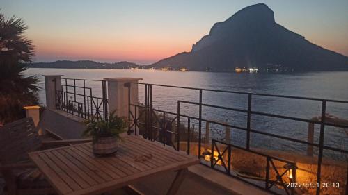 a balcony with a table and a view of the water at Aegean Villita on beach apartment in Kalymnos