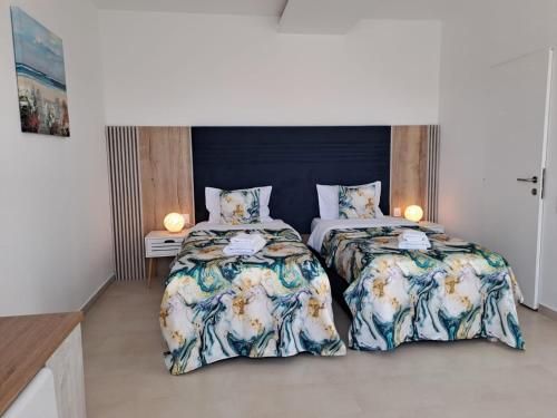 two beds sitting next to each other in a bedroom at Accent Garden in Deva
