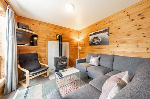 a living room with a couch and a stove at Oakview Lodge & Marina in Algonquin Highlands