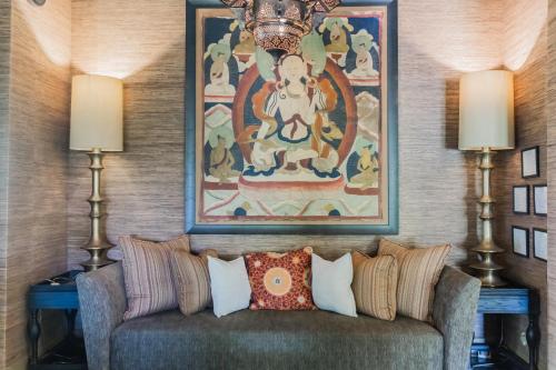 a couch in a room with a painting on the wall at Lumeria Maui, Educational Retreat Center in Makawao
