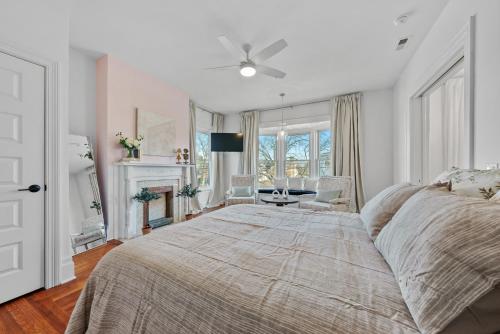 a bedroom with a large bed and a fireplace at Beautiful Condo close to Saucy Brew Works - G in Sandusky